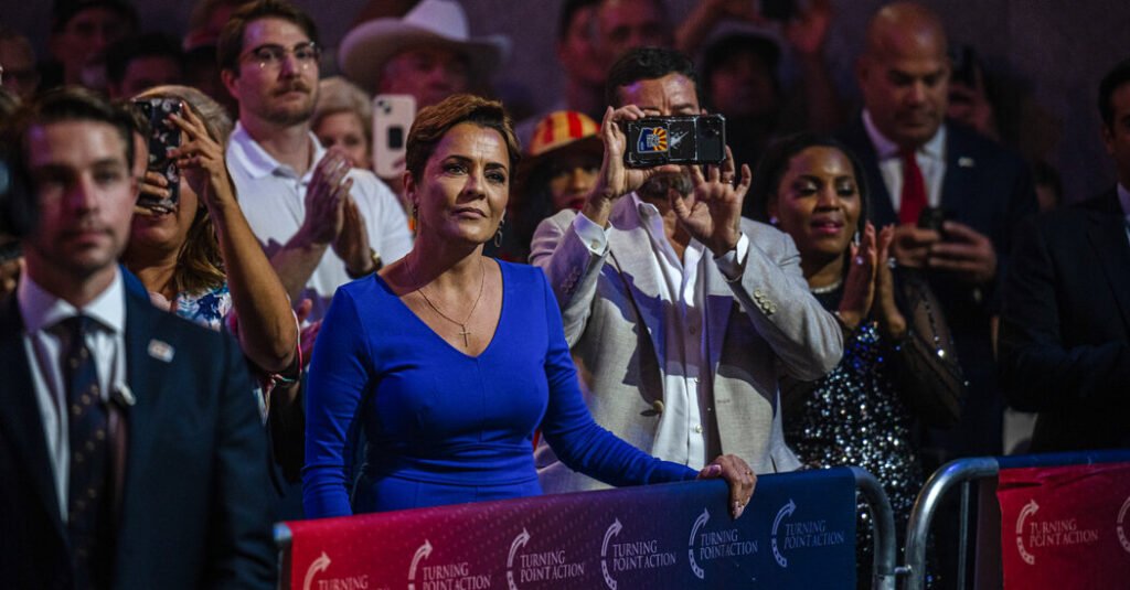 Kali Lake speaks in front of the Confederate flag