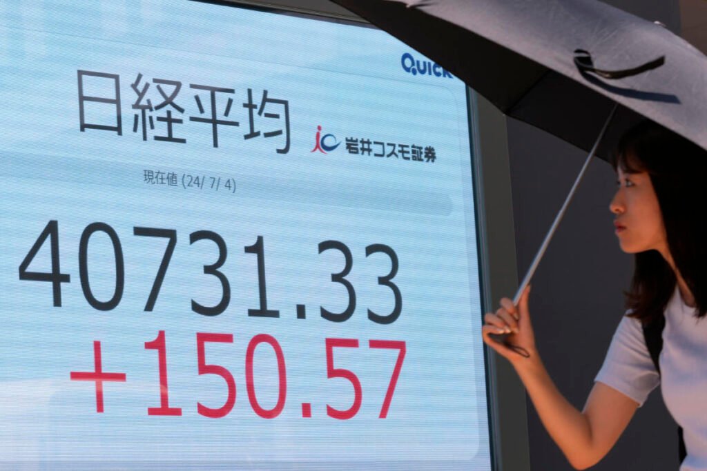 Asian stocks mostly higher as Wall Street hits new record